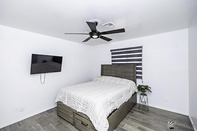 bedroom featuring wood finish floors, visible vents, ceiling fan, and baseboards