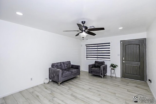 living area with recessed lighting, a ceiling fan, visible vents, baseboards, and light wood-type flooring