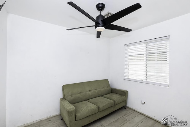 sitting room featuring ceiling fan, wood finished floors, and visible vents