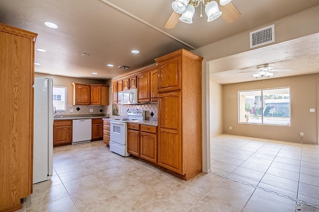 kitchen featuring ceiling fan, white appliances, light tile patterned flooring, and tasteful backsplash