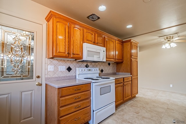 kitchen with tasteful backsplash, white appliances, and ceiling fan