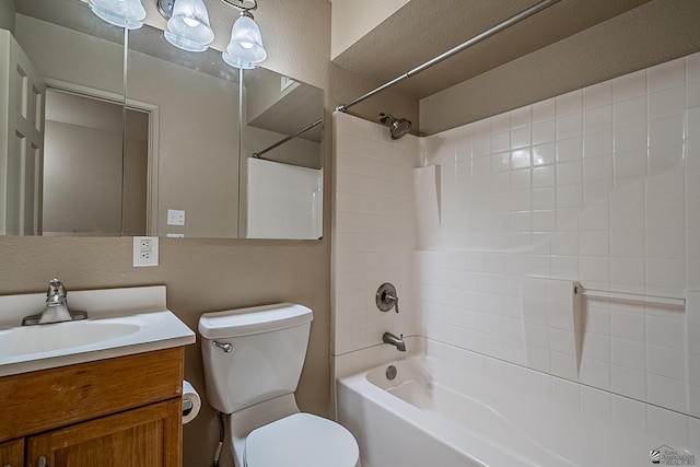 full bathroom with vanity, toilet, and tiled shower / bath