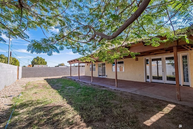 view of yard featuring french doors and a patio