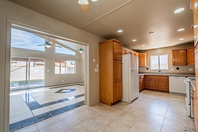 kitchen featuring sink, white appliances, plenty of natural light, ceiling fan, and decorative backsplash