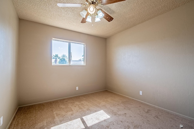 unfurnished room featuring ceiling fan, light colored carpet, and a textured ceiling