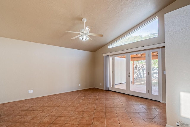 tiled spare room with a textured ceiling, vaulted ceiling, french doors, and ceiling fan