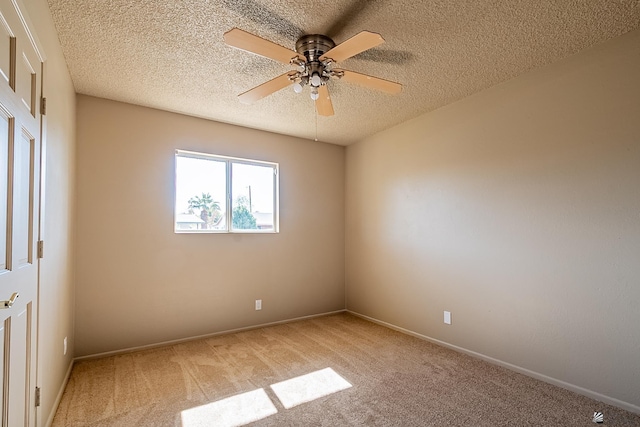 unfurnished room featuring ceiling fan, carpet floors, and a textured ceiling