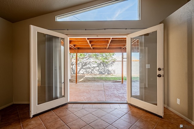 entryway with tile patterned flooring and french doors