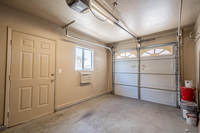 garage featuring a garage door opener and a wall mounted AC