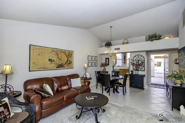 living room featuring a notable chandelier, light tile patterned flooring, and vaulted ceiling