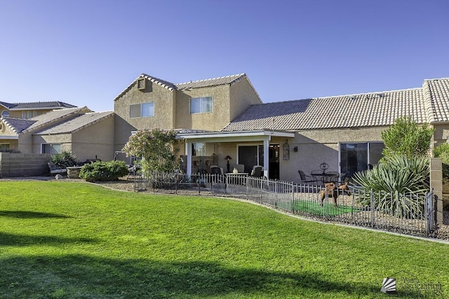 rear view of property with a patio area and a lawn