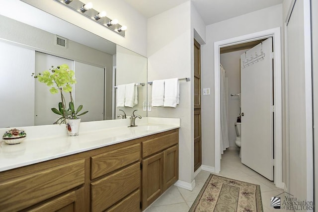 bathroom with tile patterned flooring, vanity, toilet, and a shower with shower curtain