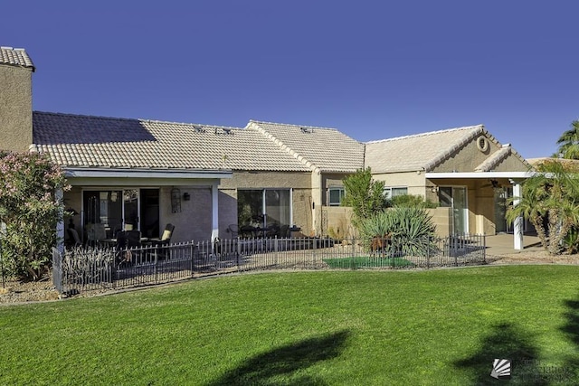 back of house with a patio area and a yard