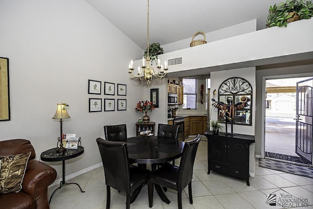 dining room featuring light tile patterned floors, high vaulted ceiling, and an inviting chandelier