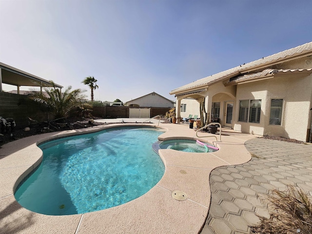 view of swimming pool featuring an in ground hot tub and a patio