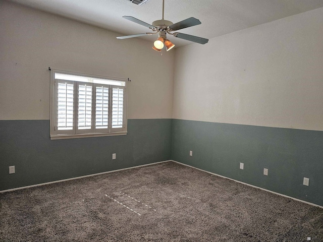 carpeted empty room featuring ceiling fan and lofted ceiling