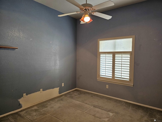 carpeted spare room with ceiling fan