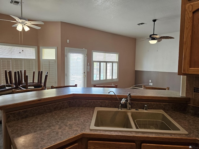 kitchen featuring a textured ceiling and sink