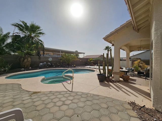 view of pool featuring an in ground hot tub and a patio