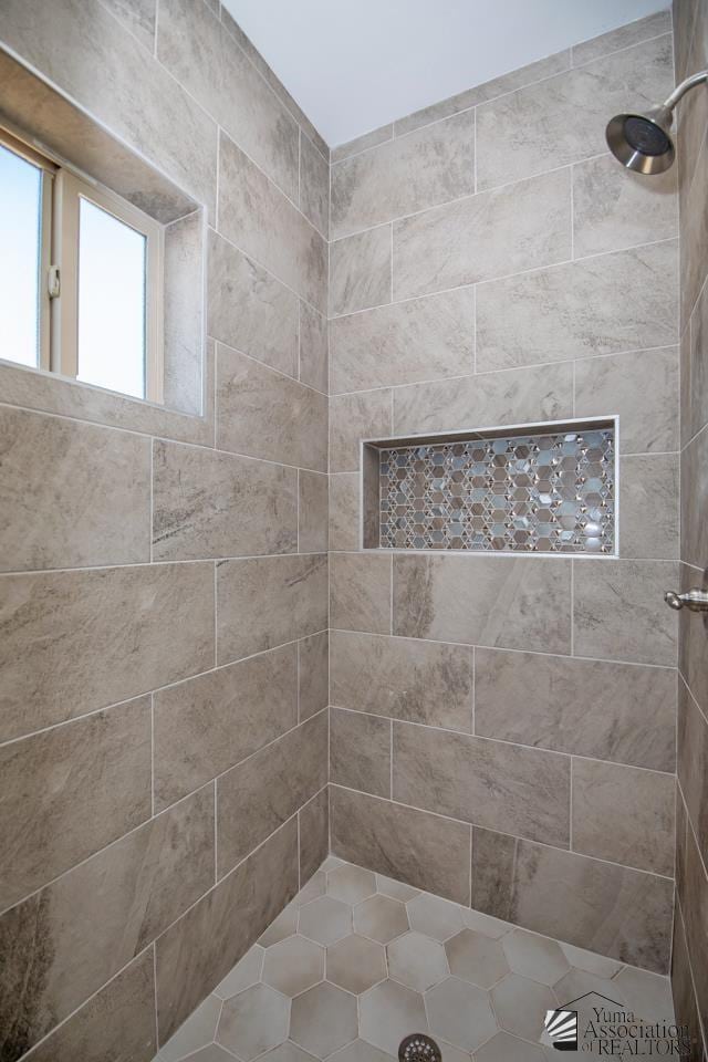 bathroom with a tile shower