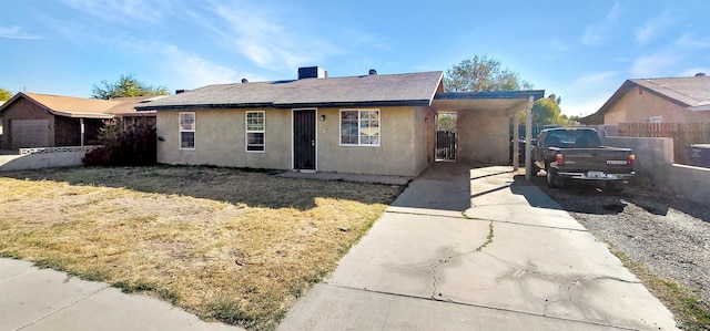 ranch-style home with a front lawn and a carport