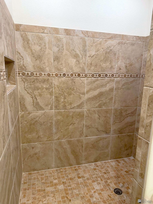 bathroom with a tile shower