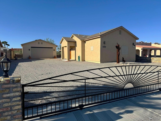 view of front of property with a garage and an outdoor structure