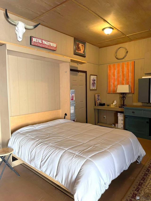 bedroom with wooden walls and wood ceiling