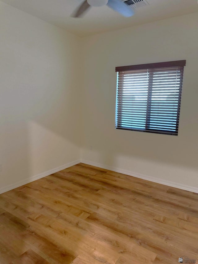 empty room featuring ceiling fan and light hardwood / wood-style floors