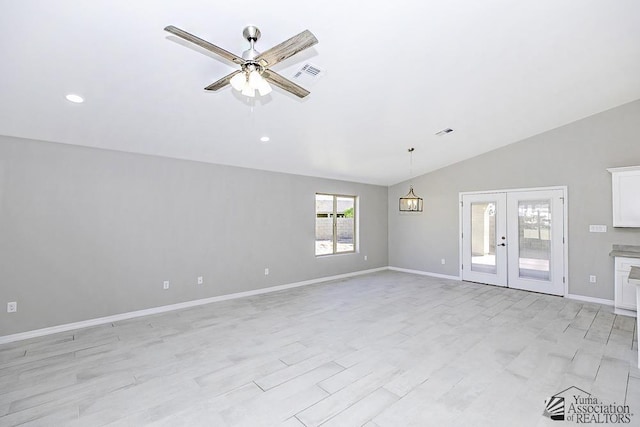 unfurnished living room with ceiling fan, light wood-type flooring, lofted ceiling, and french doors