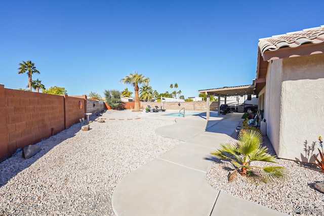 view of yard with a fenced in pool and a patio