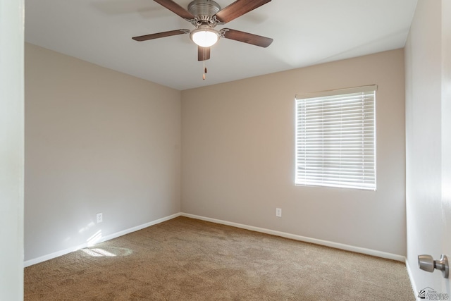 carpeted empty room featuring ceiling fan