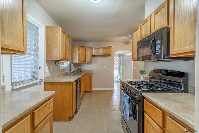 kitchen with black appliances, a healthy amount of sunlight, sink, and light brown cabinets