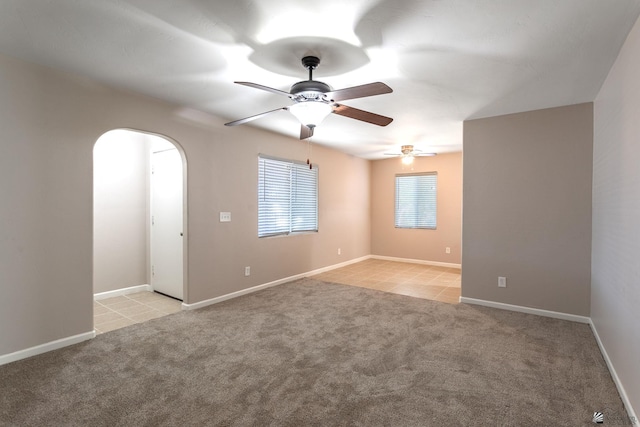 spare room with ceiling fan and light tile patterned floors