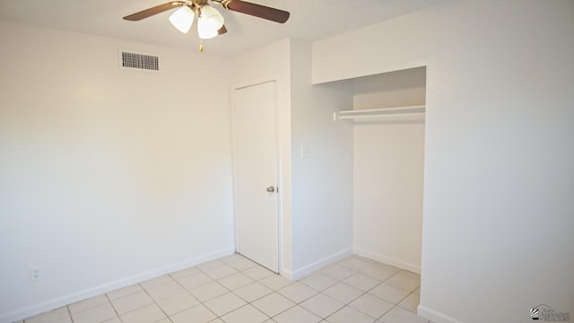 unfurnished bedroom with ceiling fan and a closet