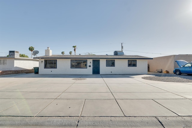 ranch-style house with central AC unit, a patio area, and stucco siding