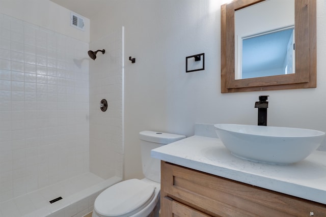 bathroom with toilet, a stall shower, visible vents, and vanity