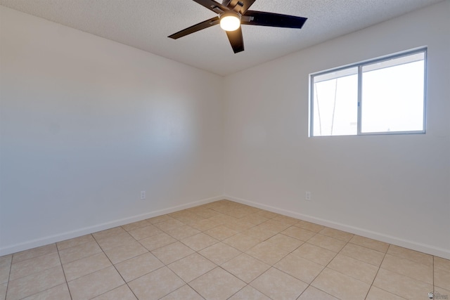 unfurnished room with a ceiling fan, a textured ceiling, baseboards, and light tile patterned floors