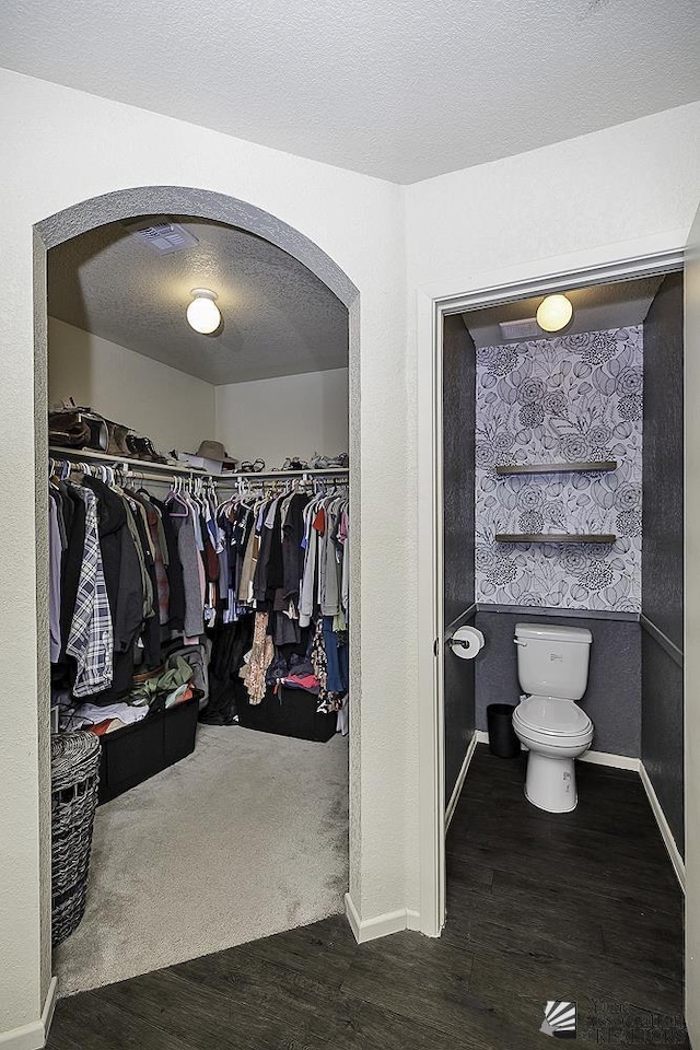 spacious closet featuring dark hardwood / wood-style flooring