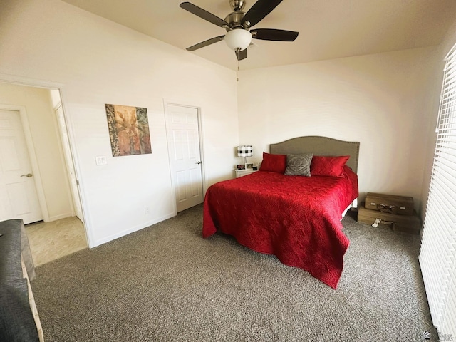 carpeted bedroom with ceiling fan, baseboards, and vaulted ceiling