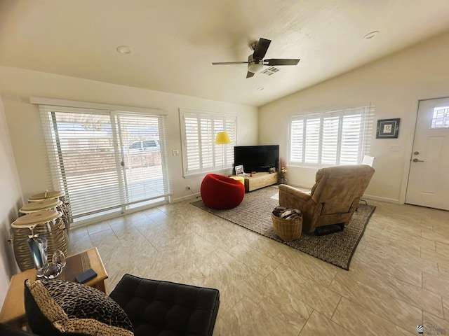 living area with a healthy amount of sunlight, vaulted ceiling, baseboards, and ceiling fan