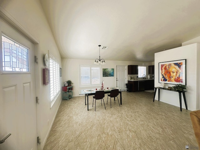 dining room with vaulted ceiling, baseboards, and an inviting chandelier