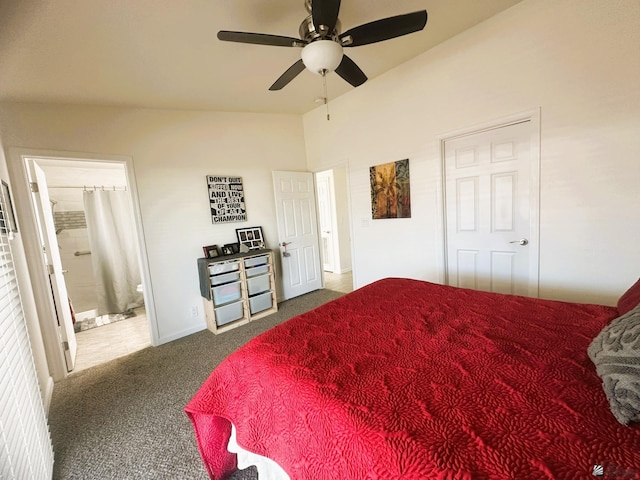 carpeted bedroom featuring lofted ceiling, connected bathroom, and a ceiling fan