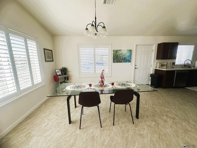 dining room with lofted ceiling, a chandelier, and a healthy amount of sunlight