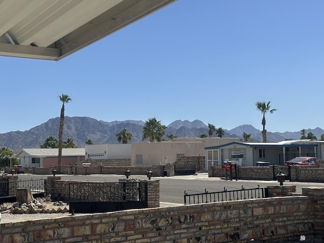 view of patio with a fenced front yard and a mountain view