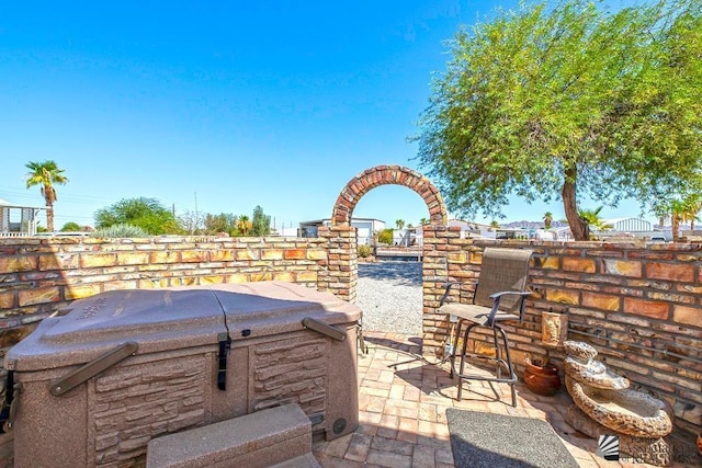 view of patio / terrace with a hot tub