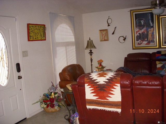 living room with tile patterned flooring and ceiling fan