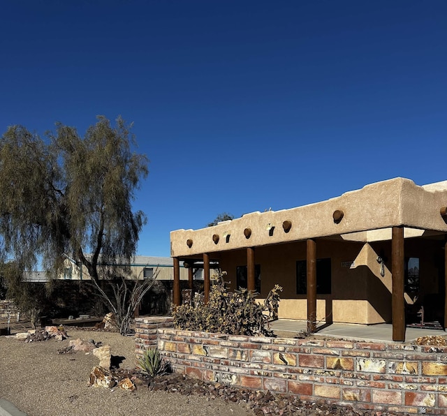 back of property featuring a patio