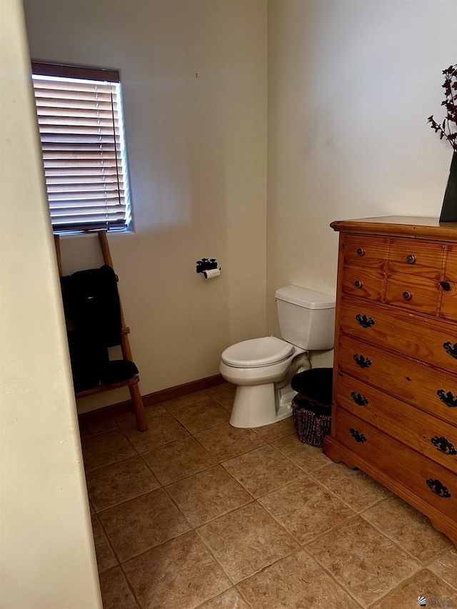 bathroom with tile patterned floors and toilet