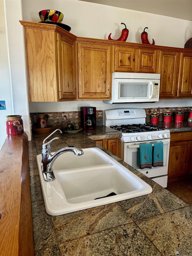 kitchen with sink and white appliances